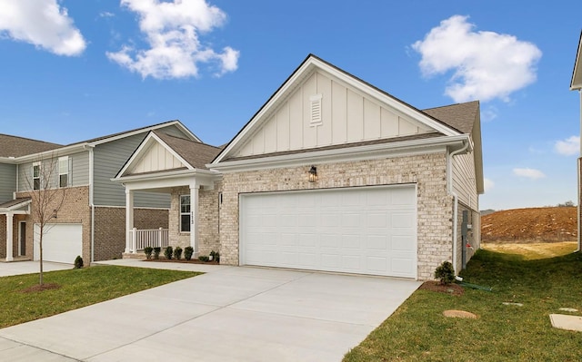 view of front of property featuring a garage, a front yard, and covered porch