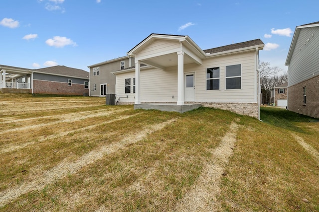 back of property featuring central AC, a yard, and a patio