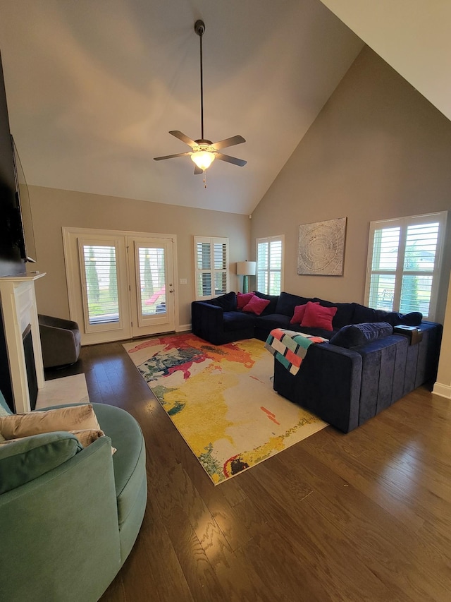 living room with ceiling fan, high vaulted ceiling, and dark hardwood / wood-style flooring