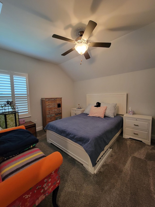 bedroom with lofted ceiling, dark carpet, and ceiling fan