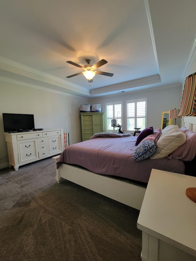 carpeted bedroom featuring a raised ceiling, crown molding, and ceiling fan