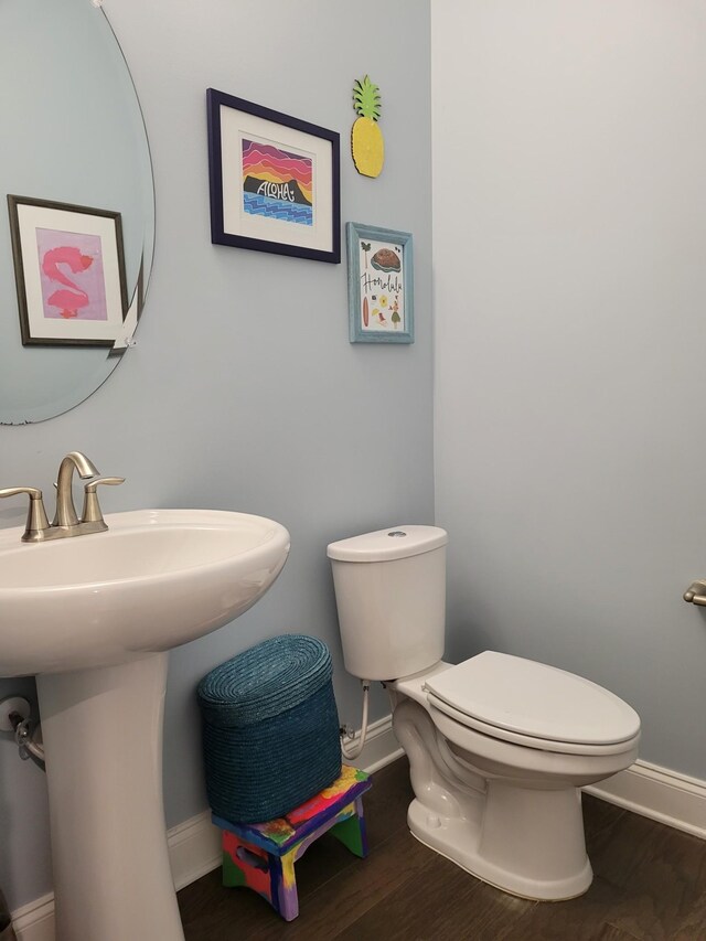 bathroom with sink, hardwood / wood-style floors, and toilet