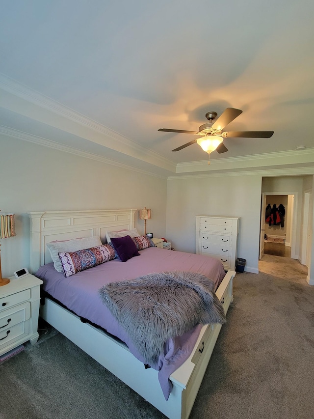 bedroom featuring dark colored carpet, ornamental molding, and ceiling fan