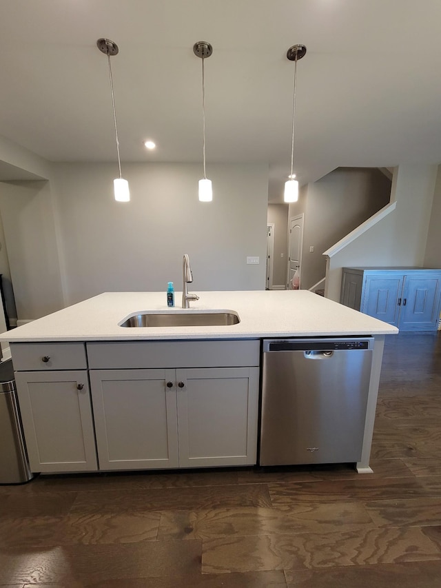 kitchen featuring sink, stainless steel dishwasher, a kitchen island with sink, and decorative light fixtures