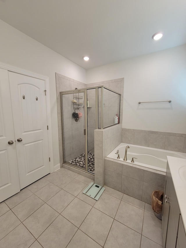 bathroom featuring vanity, plus walk in shower, and tile patterned flooring