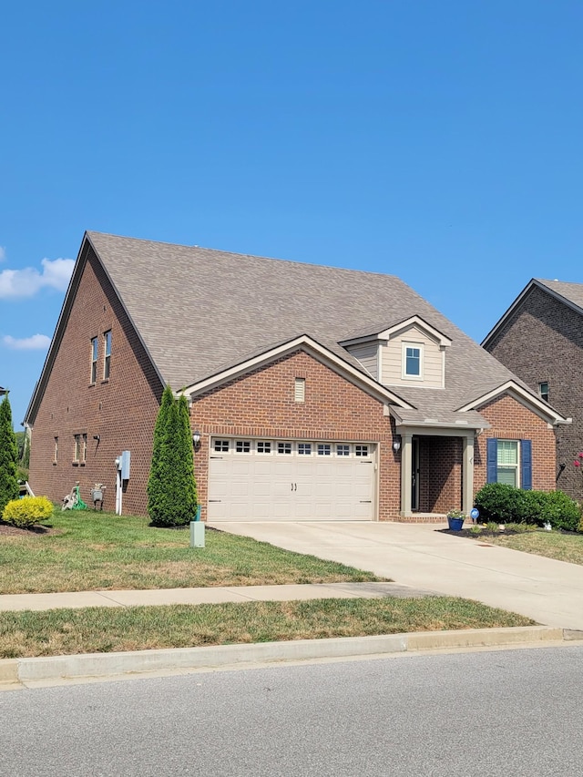 view of front of house featuring a garage and a front yard