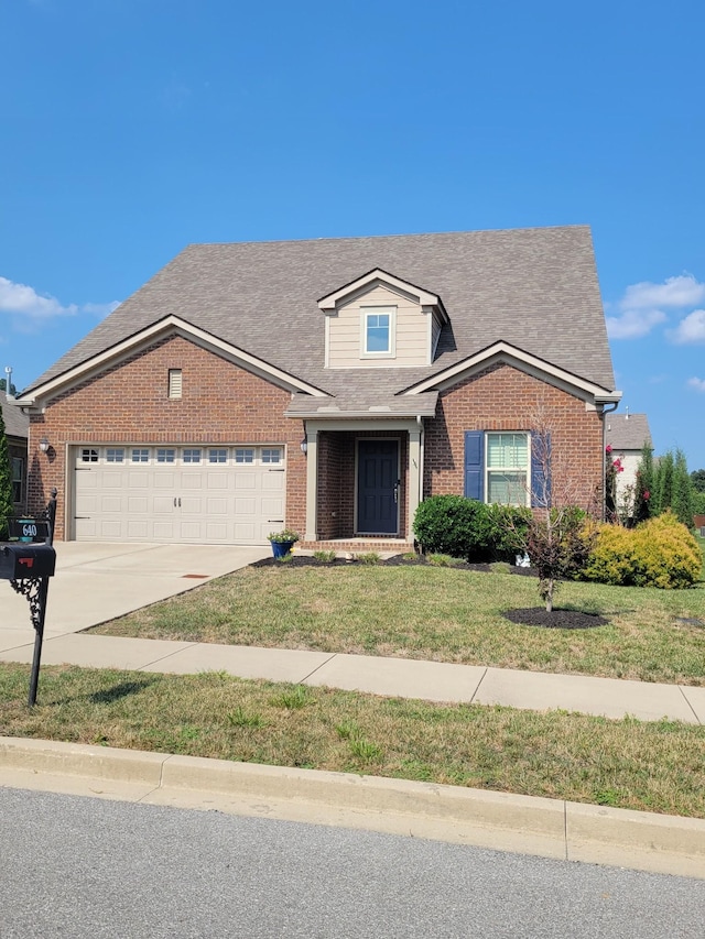 view of front of house with a garage and a front yard