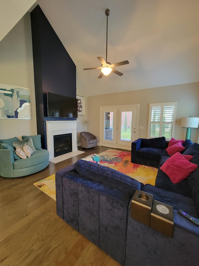 living room with wood-type flooring, high vaulted ceiling, and ceiling fan