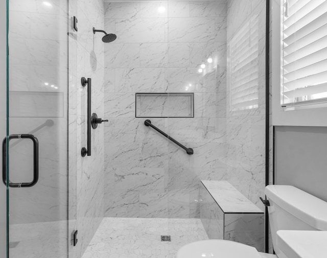 bathroom with an enclosed shower and toilet