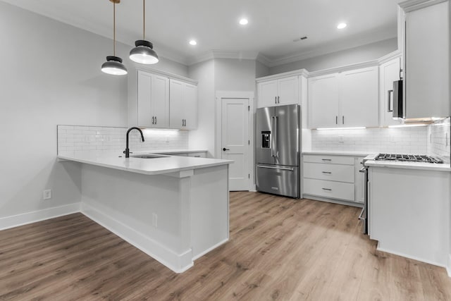 kitchen featuring pendant lighting, light hardwood / wood-style flooring, white cabinets, high end refrigerator, and kitchen peninsula