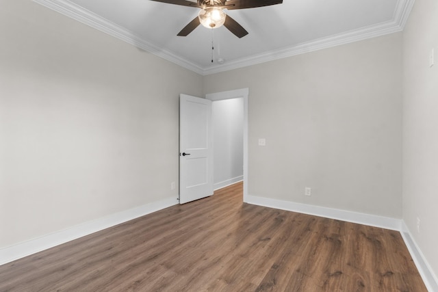 spare room with ornamental molding, dark hardwood / wood-style floors, and ceiling fan