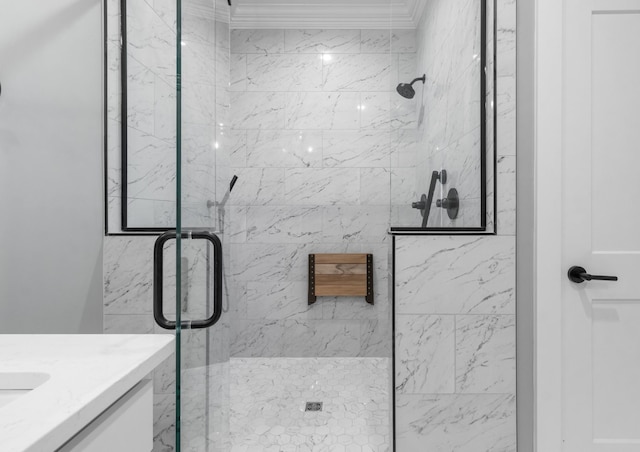 bathroom with vanity, ornamental molding, and a shower with door