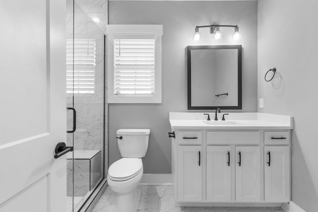 bathroom featuring vanity, an enclosed shower, and toilet