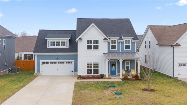 view of front of home with a porch, a garage, central AC unit, and a front yard