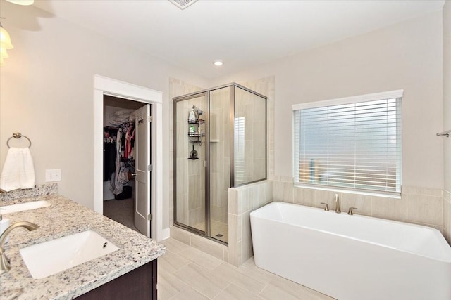 bathroom with vanity and independent shower and bath