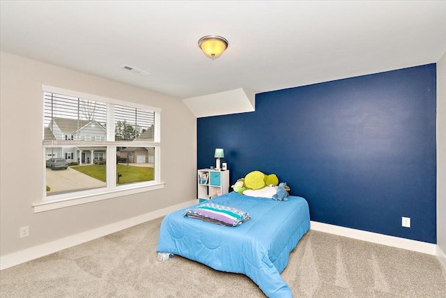 bedroom featuring lofted ceiling and carpet flooring