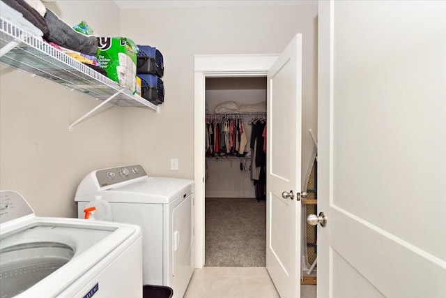 washroom with light colored carpet and washer and dryer