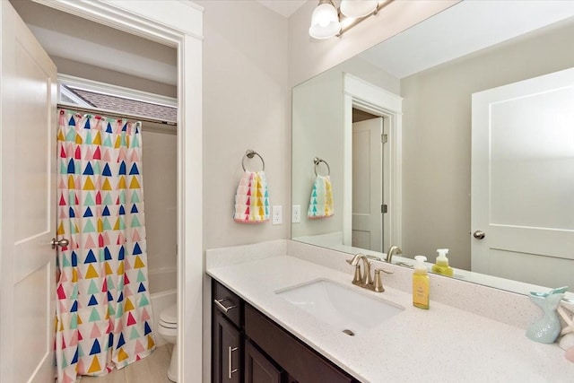 full bathroom with vanity, shower / bath combo, and toilet