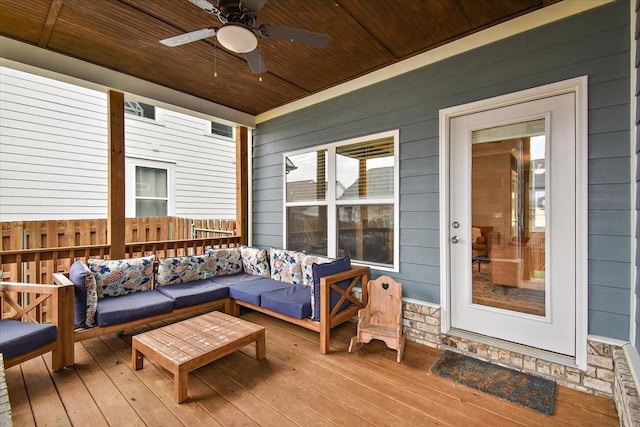 wooden terrace with an outdoor hangout area and ceiling fan