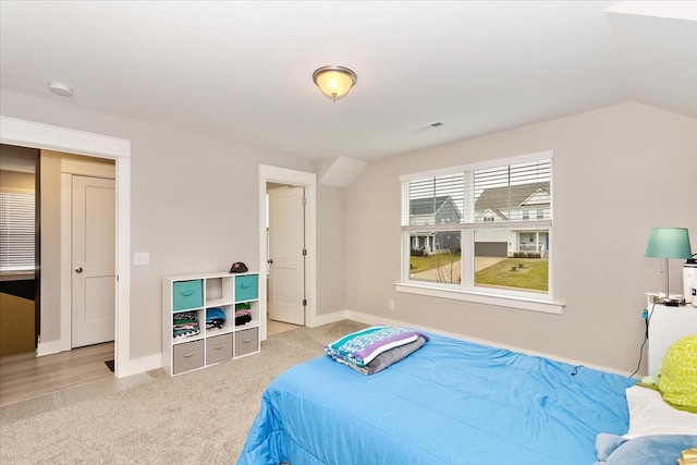 carpeted bedroom with vaulted ceiling