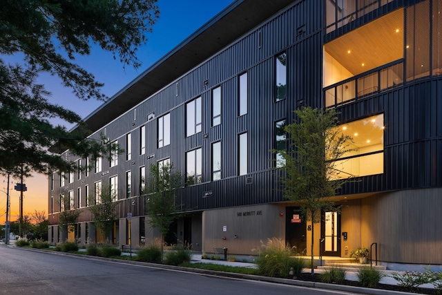 view of outdoor building at dusk