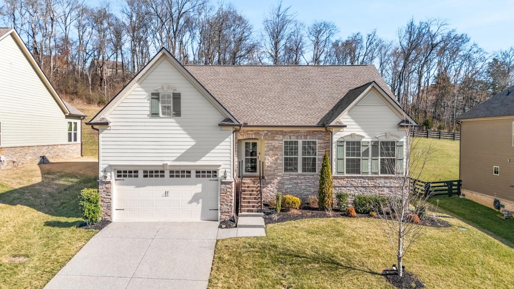 view of front of property featuring a garage and a front yard