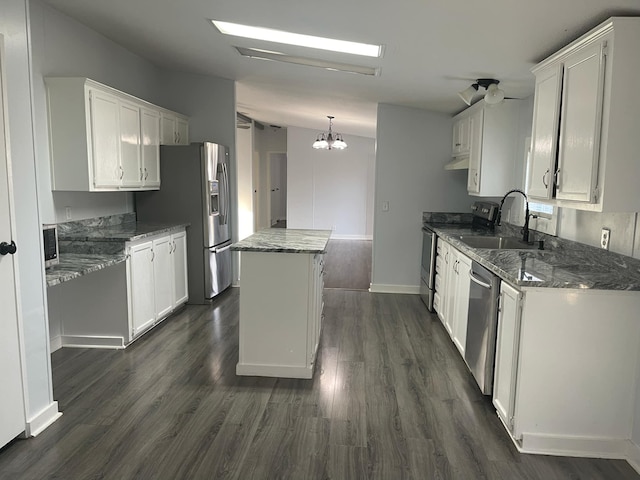 kitchen featuring a kitchen island, pendant lighting, sink, white cabinets, and stainless steel appliances