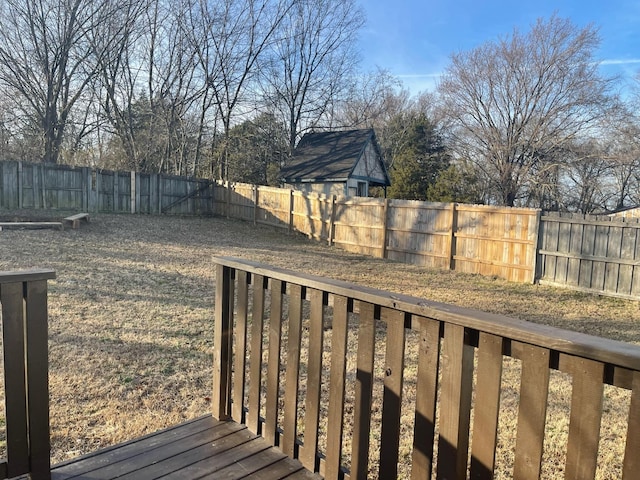 wooden deck featuring a yard