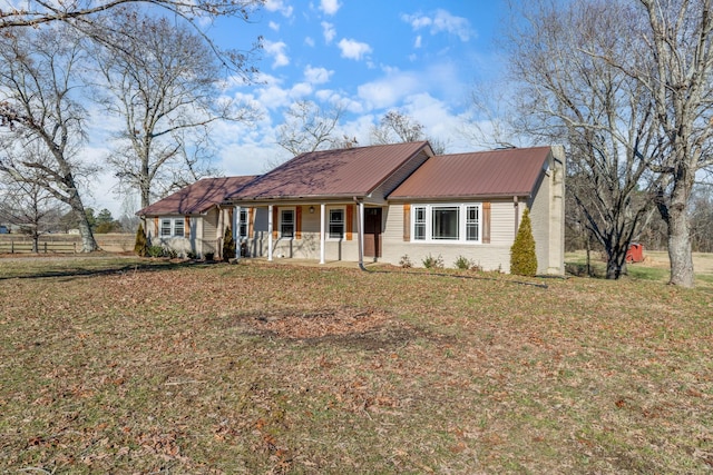 ranch-style house with covered porch and a front lawn