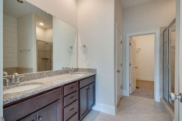 bathroom featuring vanity, an enclosed shower, and tile patterned floors