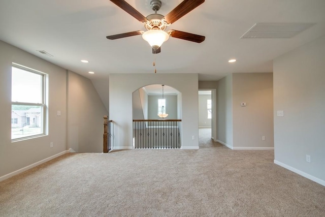 spare room featuring light carpet and a wealth of natural light