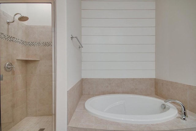 bathroom featuring separate shower and tub