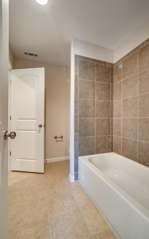 bathroom featuring tile patterned floors, toilet, and shower / bath combination