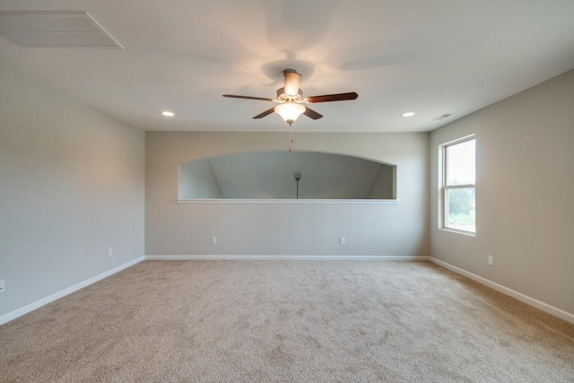 empty room with light colored carpet and ceiling fan