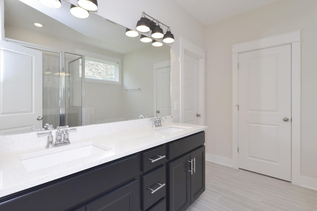 bathroom with a shower with door and vanity