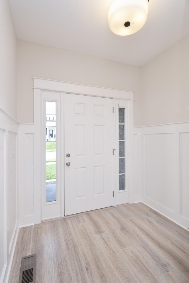 foyer entrance with light hardwood / wood-style floors