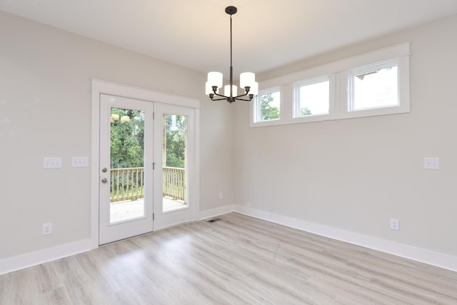 interior space with a notable chandelier and light hardwood / wood-style flooring