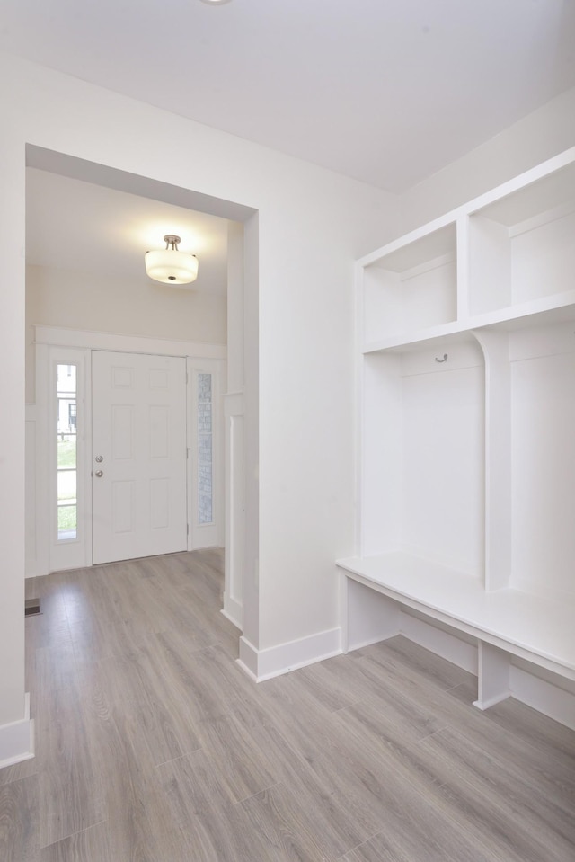 mudroom with light hardwood / wood-style floors