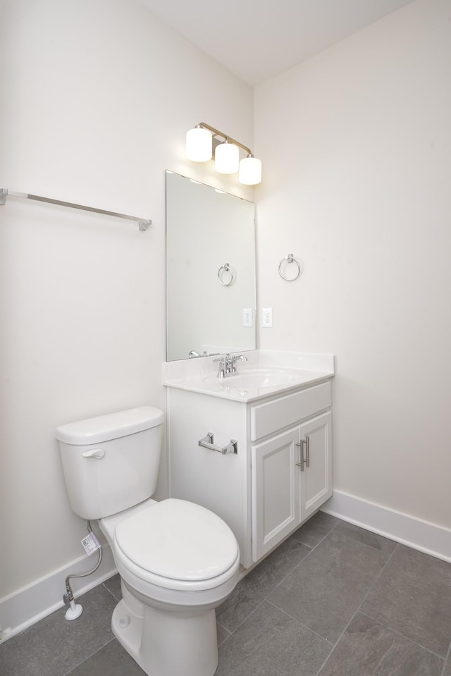 bathroom featuring vanity, tile patterned floors, and toilet