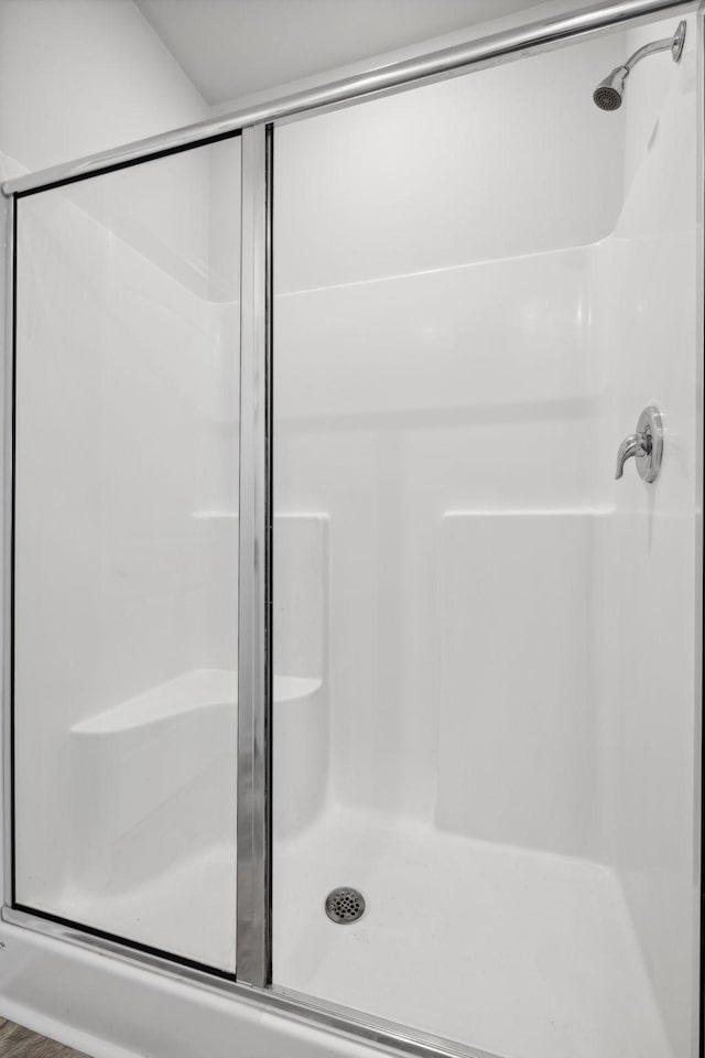 bathroom with a shower with door