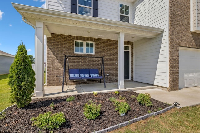 entrance to property with a porch and a garage