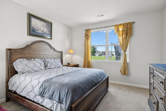 bedroom featuring light colored carpet