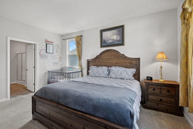 carpeted bedroom featuring ensuite bath