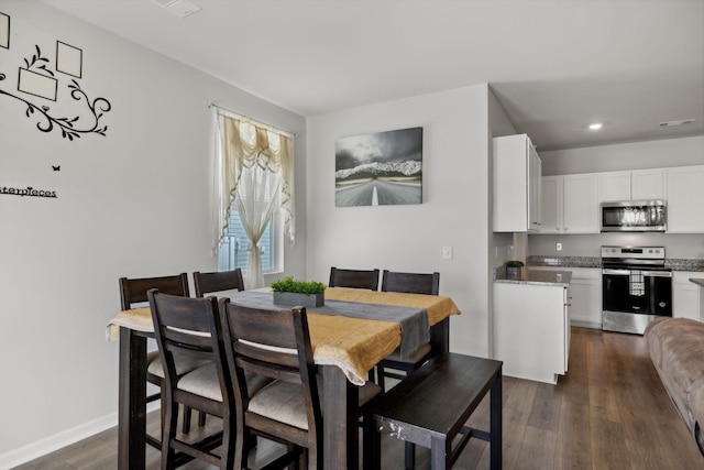 dining space with dark hardwood / wood-style flooring