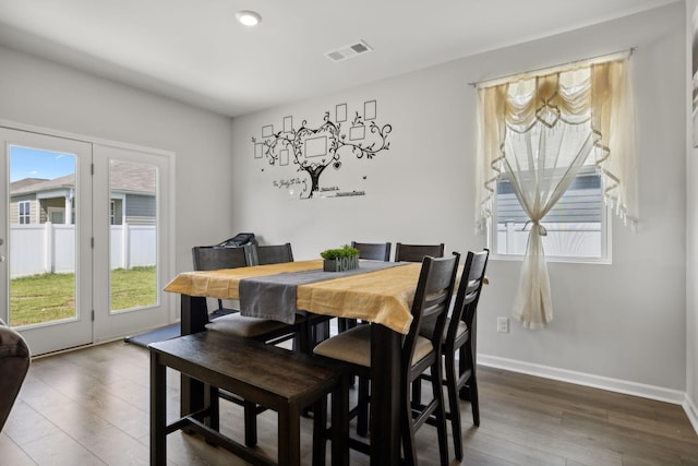 dining space featuring dark wood-type flooring