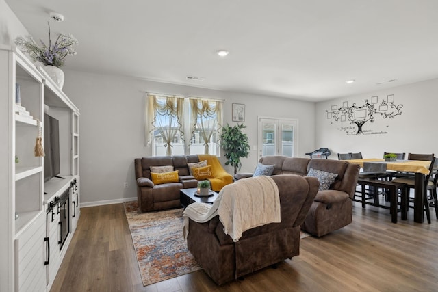 living room with dark hardwood / wood-style flooring