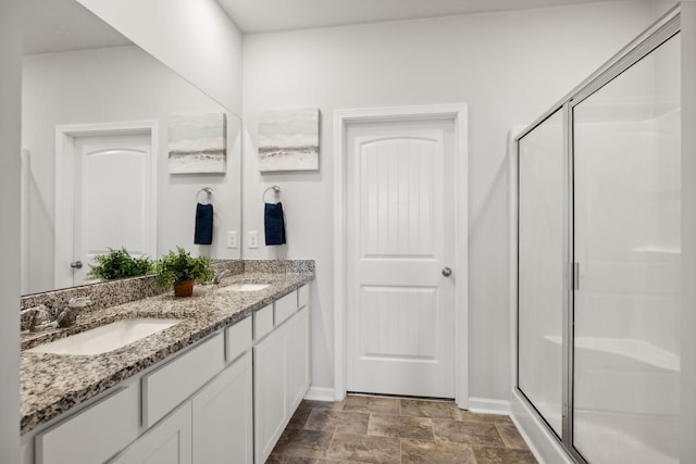 bathroom with vanity and a shower with shower door