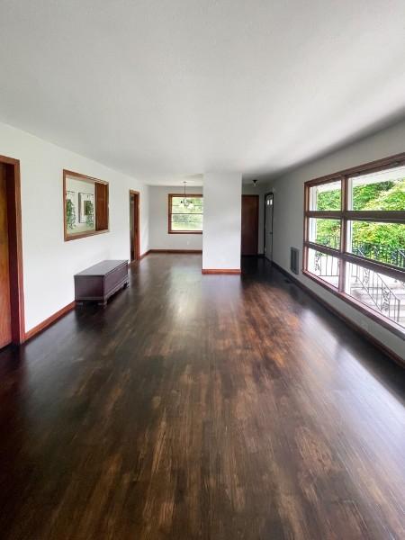 unfurnished living room with dark hardwood / wood-style flooring