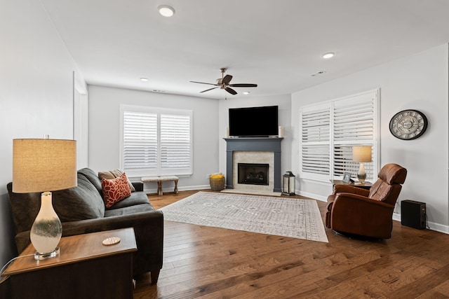 living room featuring wood-type flooring and ceiling fan