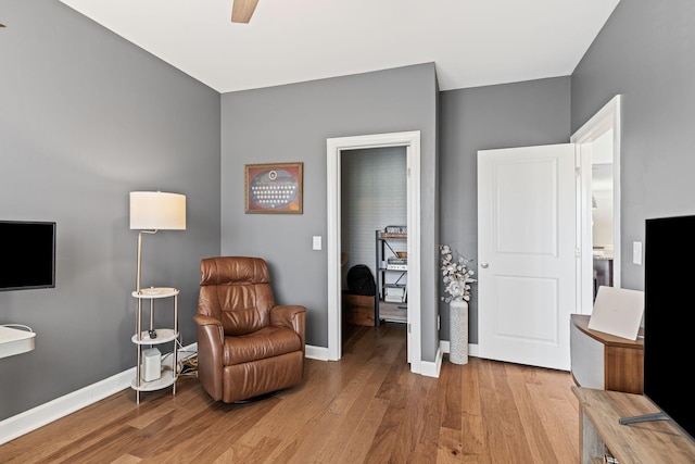 sitting room featuring ceiling fan and light wood-type flooring